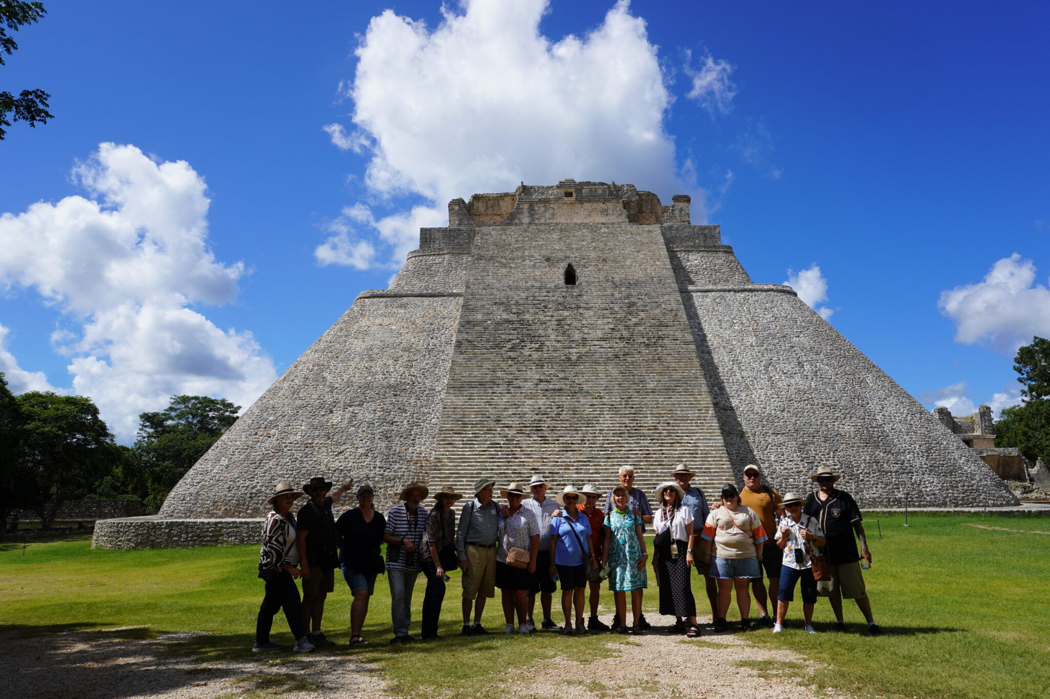 Adventure and culture tour in Mexico: Odyssey travelers with their guide at the Pyramid of the Magician in Uxmal