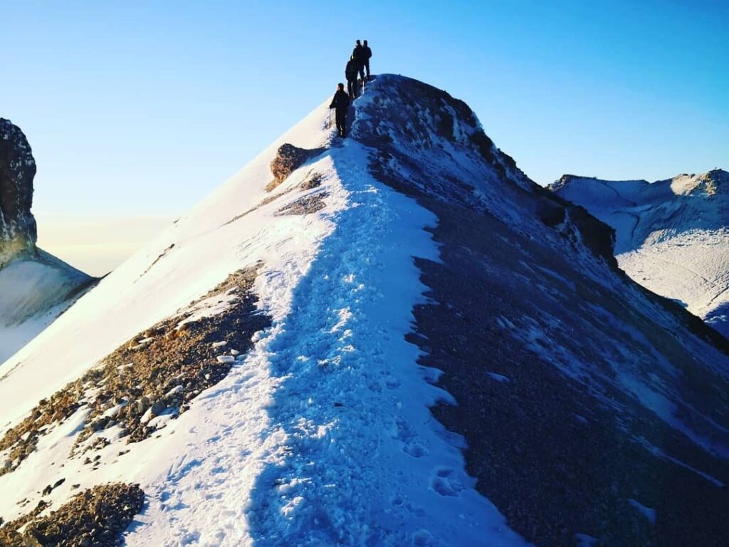 Climbers on the snowy ridge of Iztaccíhuatl at first light