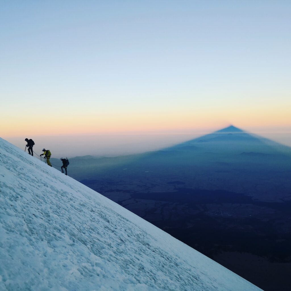 Shadow of Pico de Orizaba cast over the clouds at sunrise
