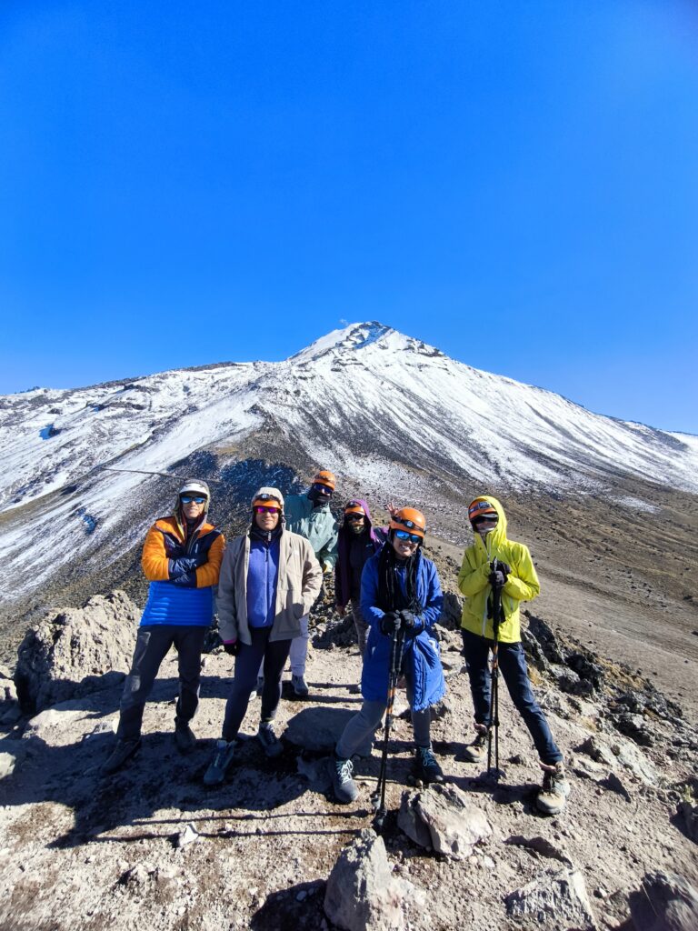 Mountaineering group in front of the snow-capped Pico de Orizaba